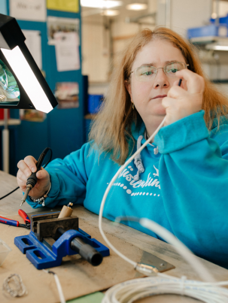 Eine Frau prüft ein Kabel.